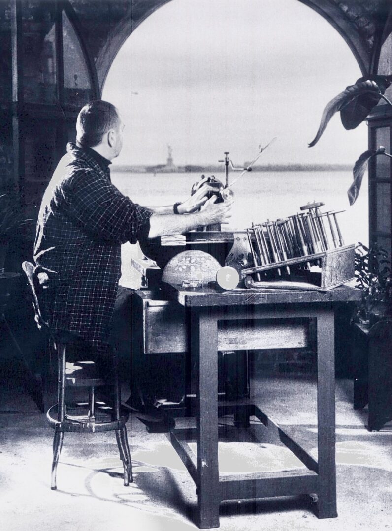 A woman sitting at a table with papers on it.